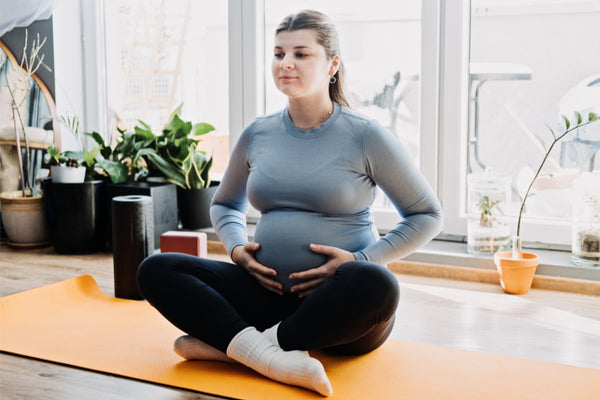 Pregnant woman doing relaxation exercise