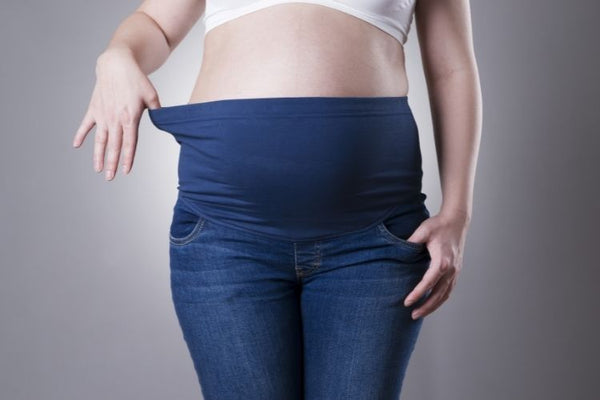 A woman wearing pregnancy jeans