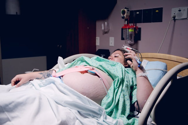 Pregnant woman waiting to give birth in maternity ward