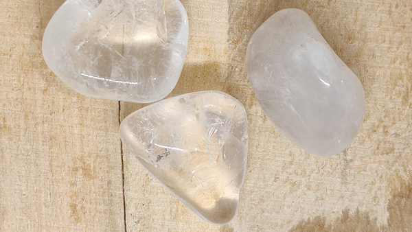 clear quartz crystal on wooden background