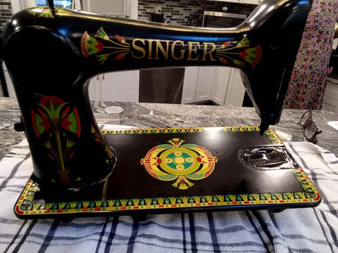 Singer 66 sewing machine, back view, with freshly applied lotus design decals. Machine lacks hardware and has tape covering essential areas in prep for top coat of paint.