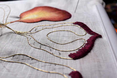 Finished iris petal in burgundy and gold shown with beginnings of new petals alongside