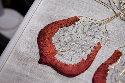 Closeup of stumpwork hand embroidery petal showing marking lines and shading
