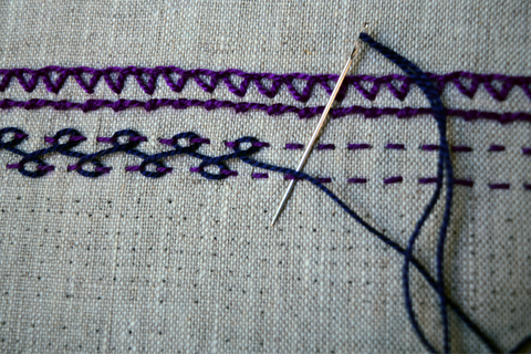 Embroidered bands in purple with navy blue interlacing threads