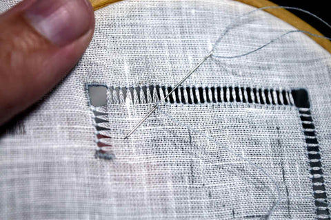 Progress on the drawn thread work; open sections satin stitch and bundles of threads created with hemstitching