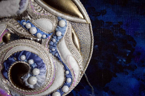 Closeup of Moon Rabbit showing area from ears to haunch, white padding is nearly covered by a variety of metal and silk threads in silver and blue as well as flat iridescent ribbon.