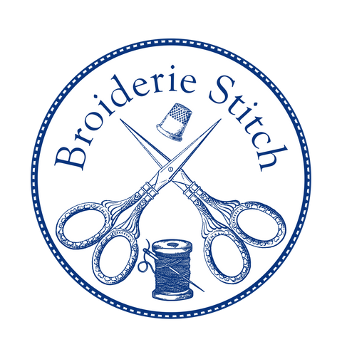 Broiderie Stitch shop logo; two crossed pairs of embroidery scissors surmounted by a thimble and the words 'Broiderie Stitch', below sits a spool of thread and needle. Design is in blue on white background, blue circle ringing it has dashed white lines like stitches.