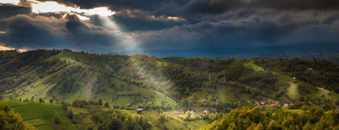 Romanian countryside under broken clouds