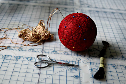 Temari thread ball with needle and scissors