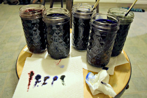 Mason jars of dye in reds, blues, and greens