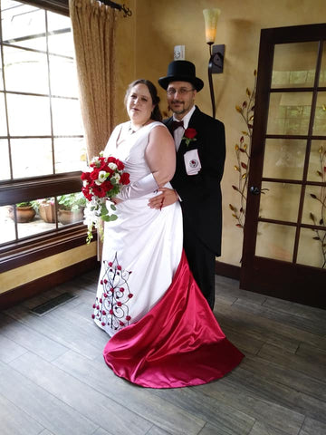 Wedding dress with roses and red train