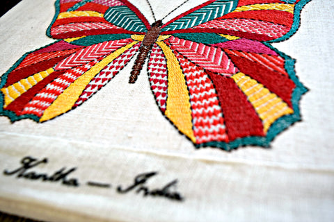 Close-up of brightly colored butterfly worked in kantha embroidery