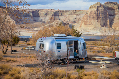 Airstream camper parked in a campsite.