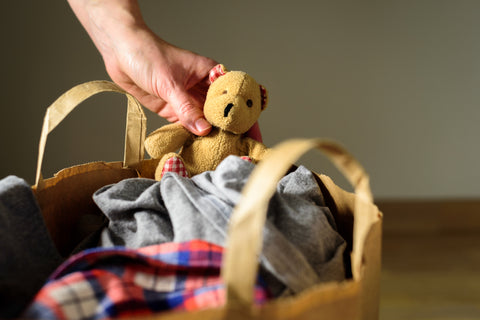Clear clutter by donating unused clothes and toys like this teddy bear to charity.