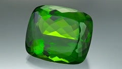 This magnificent 130.60-carat antique cushion-cut peridot displays the gem's finest attributes: a medium-toned, highly saturated yellowish green hue and high clarity. Courtesy GIA