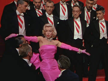 Marilyn Monroe singing Diamonds are a Girls's Best Friend in Gentlemen Prefer Blonds By 20th Century Fox - source This is a screenshot from a trailer which can be viewed here., Public Domain, https://commons.wikimedia.org/w/index.php?curid=465373