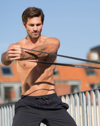 man-using-fence-for-resistance-band-chest-workout