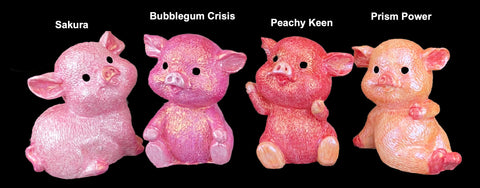 four pig models in shades of pink
