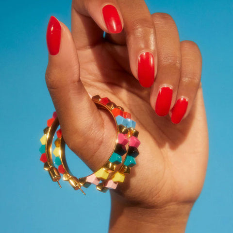 Kat Maconie prism stud large hoops in tropical/gold in models hand