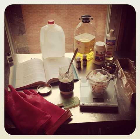 Soap making supplies spread on a kitchen counter with an old fashioned instagram filter. 