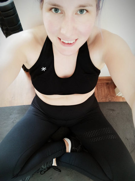 Woman in BARA Sportswear Black Tights. She is smiling and holding the camera in front of her.