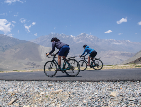 Jennifer Gurecki and Roz Groenewoud cruising on a rare flat road in Nepal.
