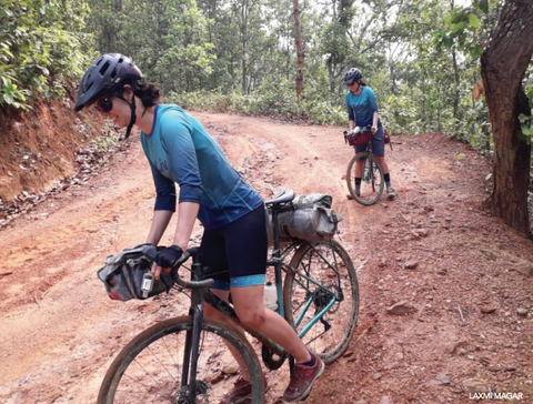 Roz Groenewoud and Jennifer Gurecki navigating a rocky Nepalese dirt road. 