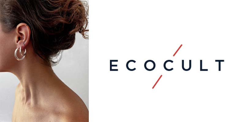 Eco Cult logo and image of model wearing astor & orion silver hoops. She has two piercings in her lobe and the hoops are different sizes. The larger silver hoop is on the bottom piercing and the medium silver hoop is on the upper piercing.