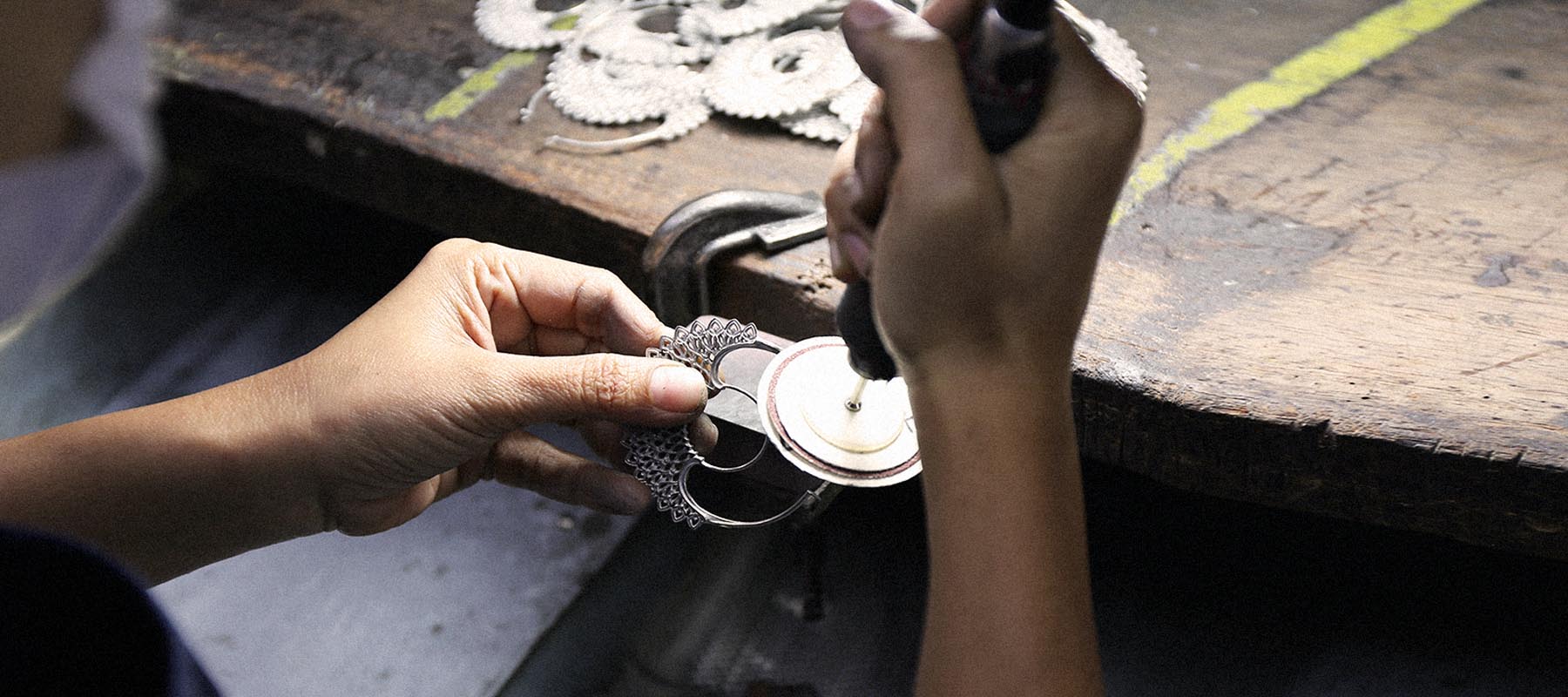 Worker's hands showing ethical jewelry making in a facility 3rd party certified for environmental and labor standards