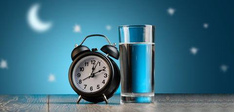 Alarm clock and glass of water