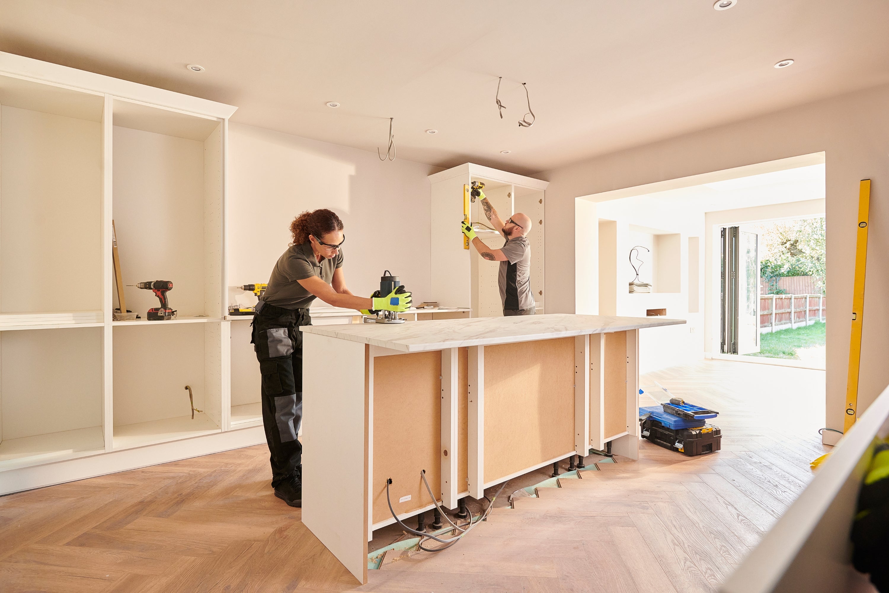 Revamping Your Kitchen: How to Incorporate Shaker Cabinets into Your Kitchen two people installing kitchen shaker cabinets