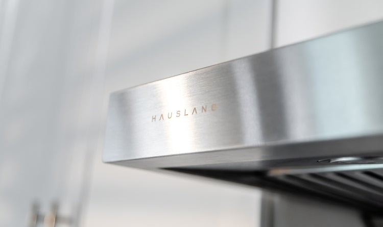 product quality image showing a hauslane range hood zoomed in on the logo