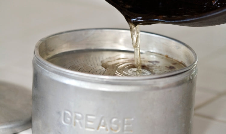 how to properly dispose of or store bacon grease photo showing pouring bacon grease into a tin container