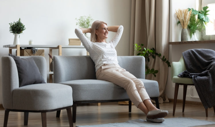 health benefits related to indoor plants. image showing woman relaxing with her plants