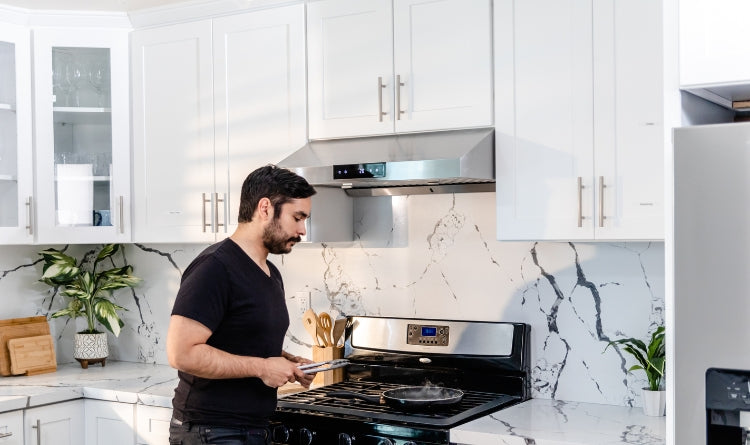 4 Innovative Ways that Charcoal can Help Your Kitchen image showing a man cooking in the kitchen with a ductless range hood that uses charcoal filters