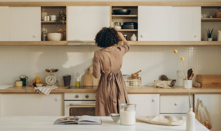 4 Innovative Ways that Charcoal can Help Your Kitchen image showing woman working in her kitchen cabinets