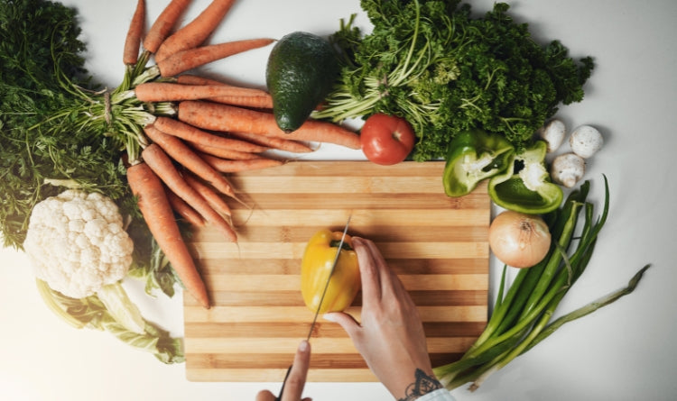 person chopping fresh vegetables