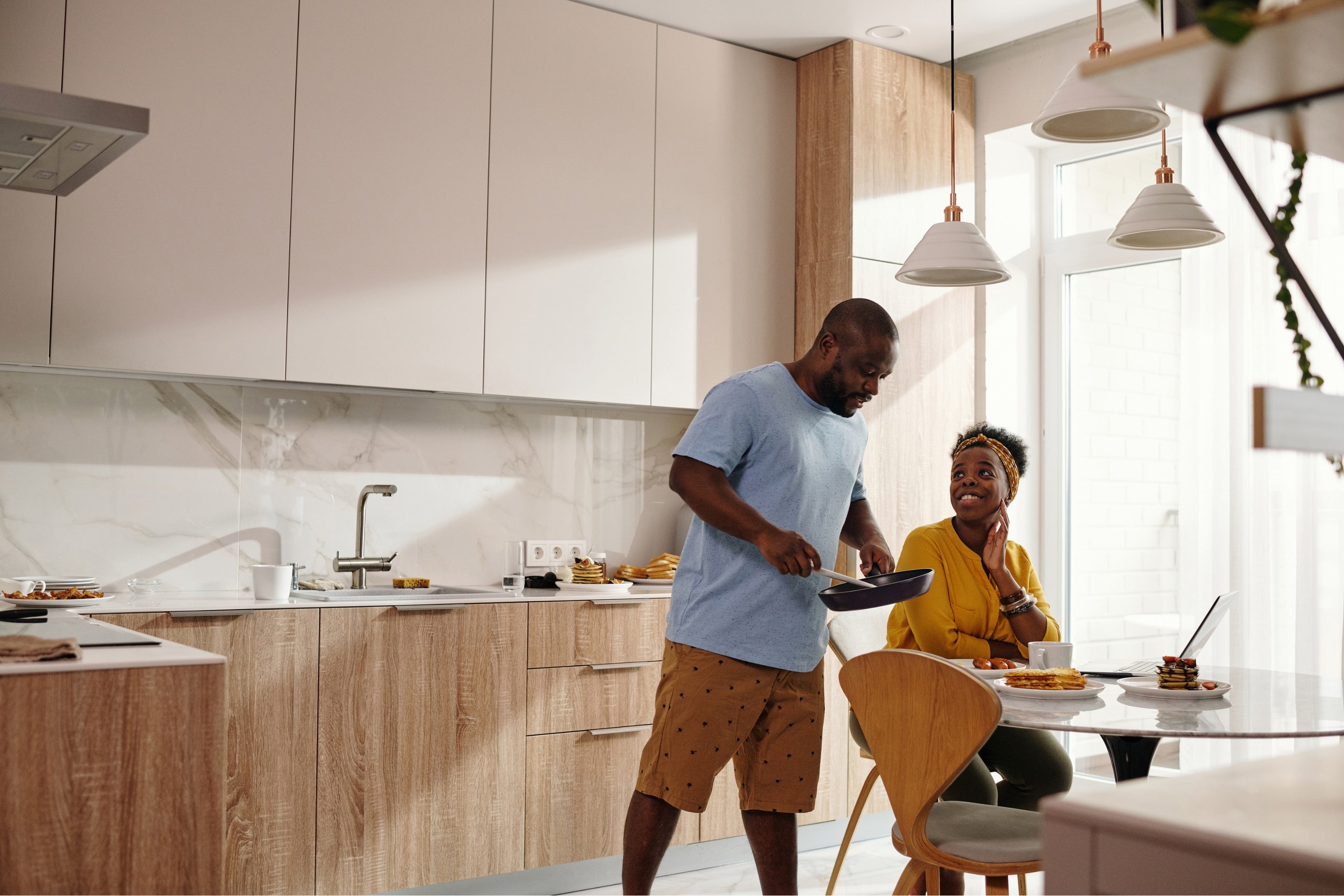 What is the Difference Between Product Warranty and Product Protection Plans? photo showing a family cooking in the kitchen with their range hood