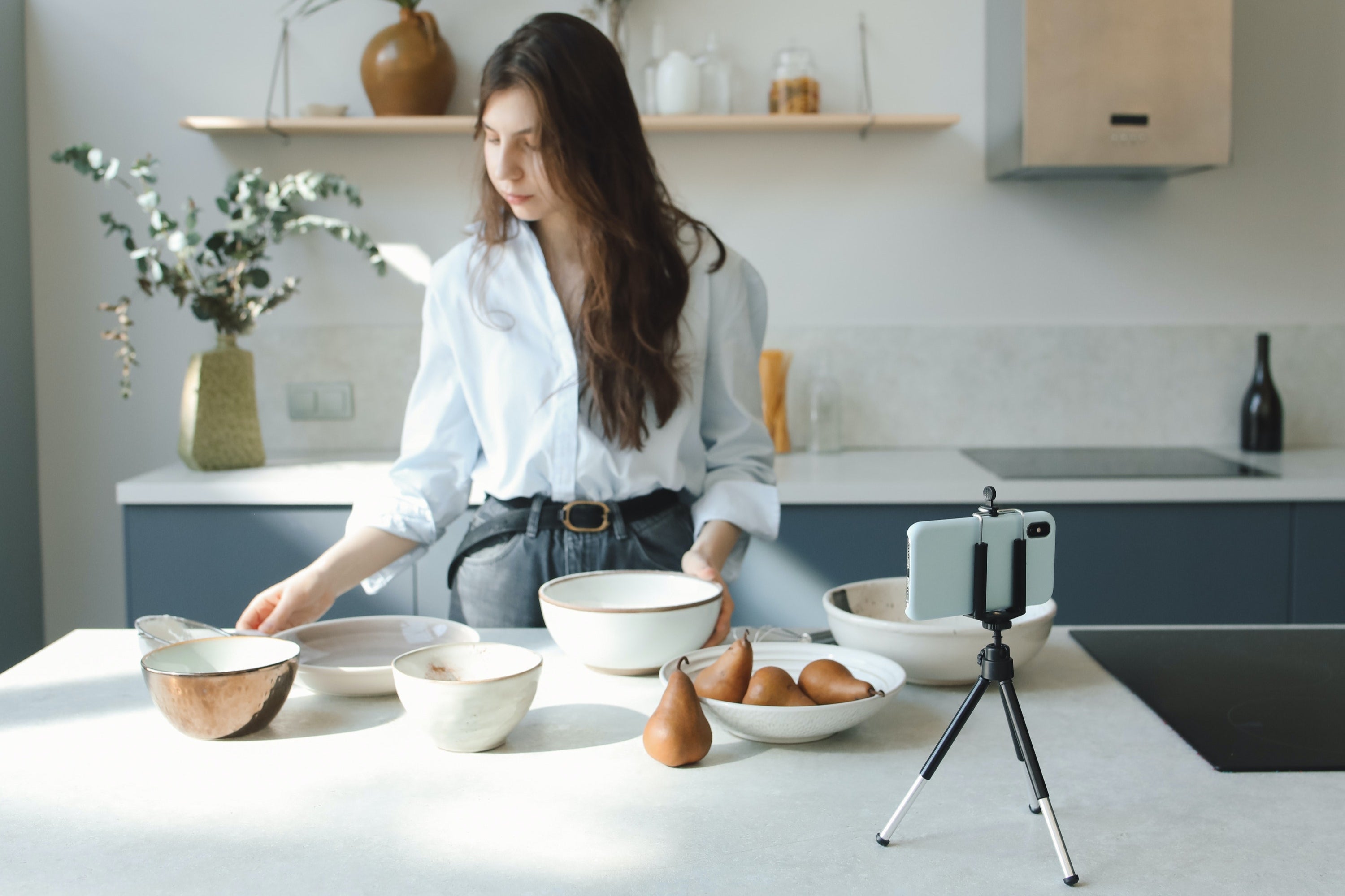 girl cooking a new recipe with affordable and powerful range hoods from hauslane