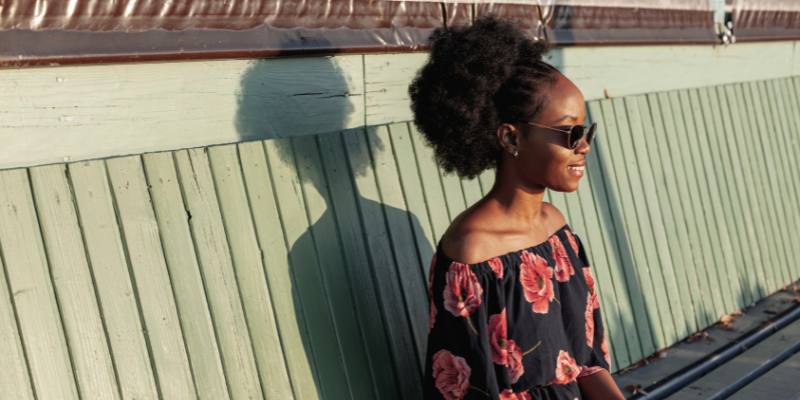 High bun afro hair female model with sunglasses