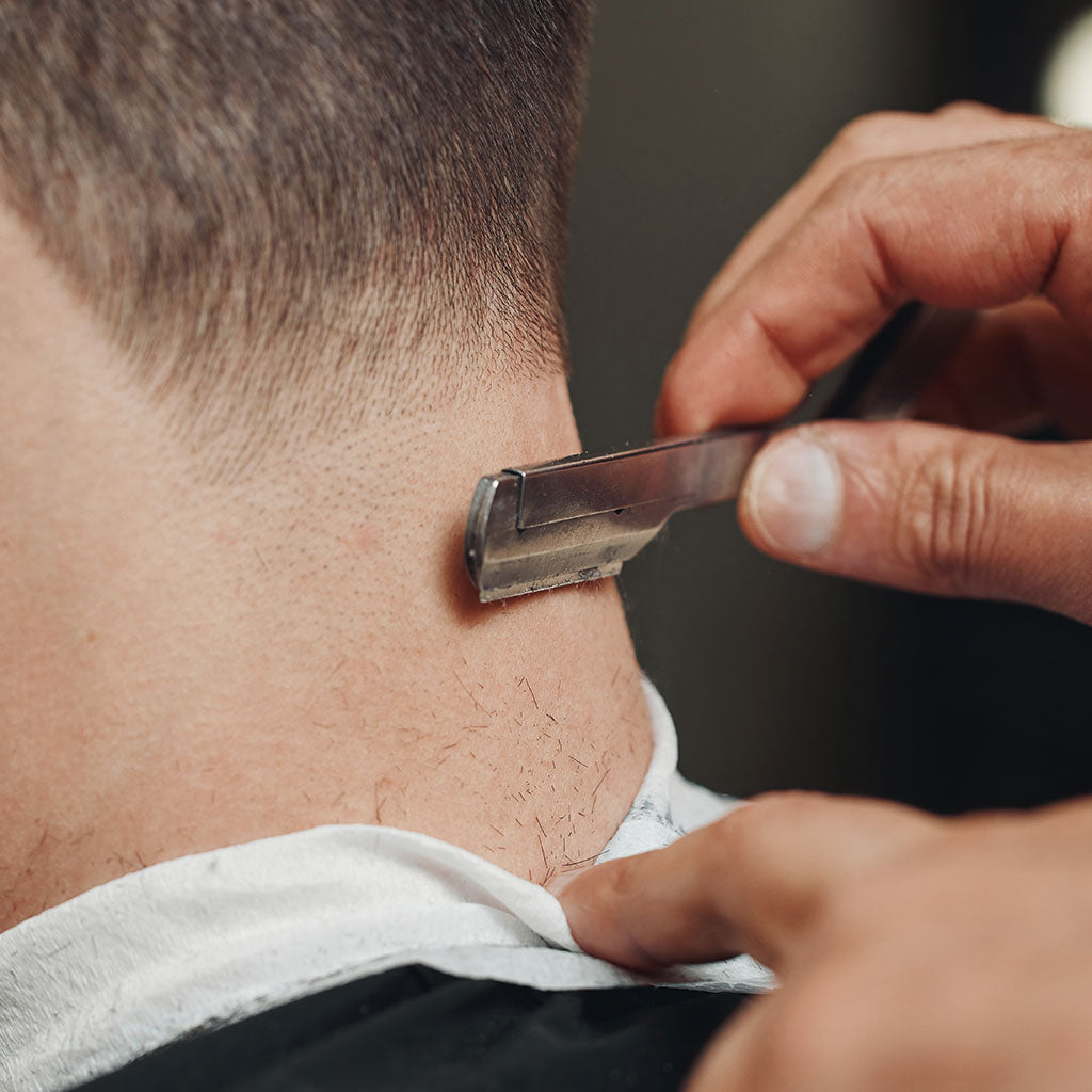 Barber Trimming A Man's Neck