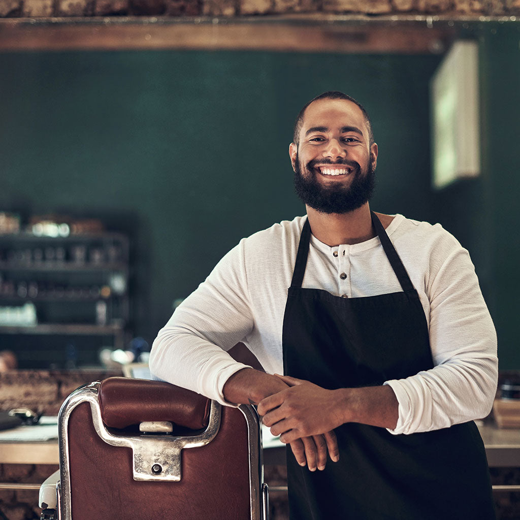 Barber leaning on barber chair