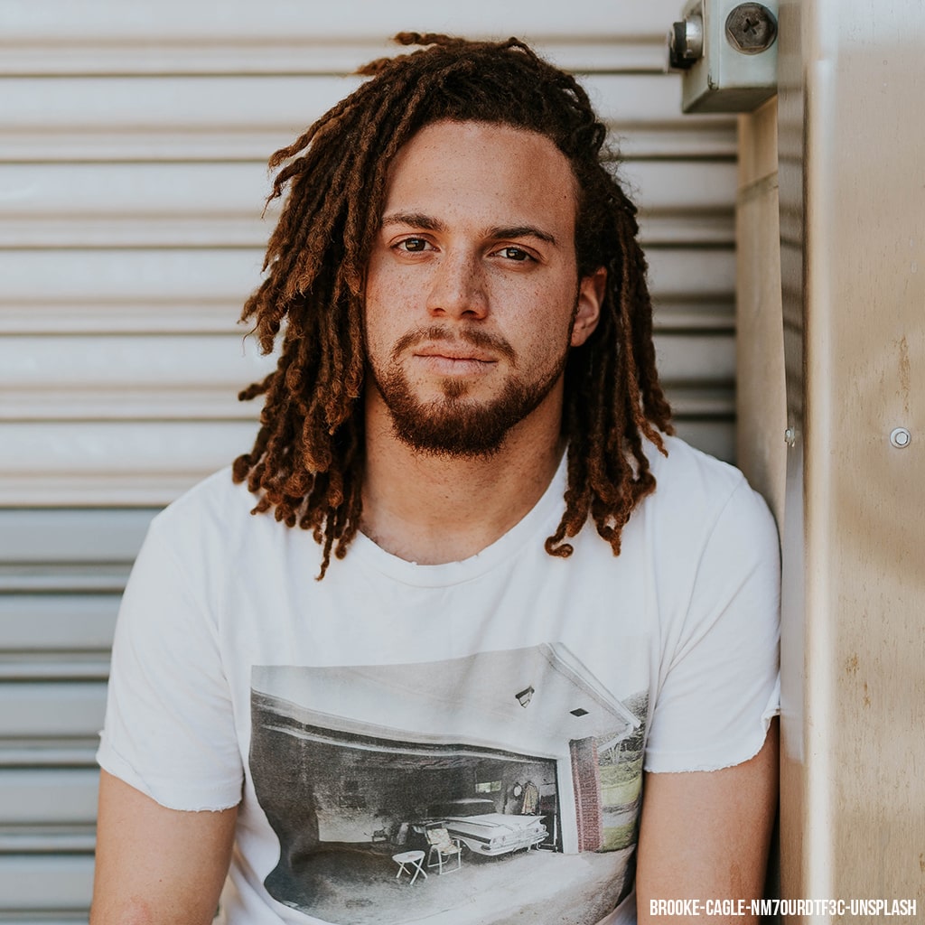 Man sitting down Wearing Dreadlocks