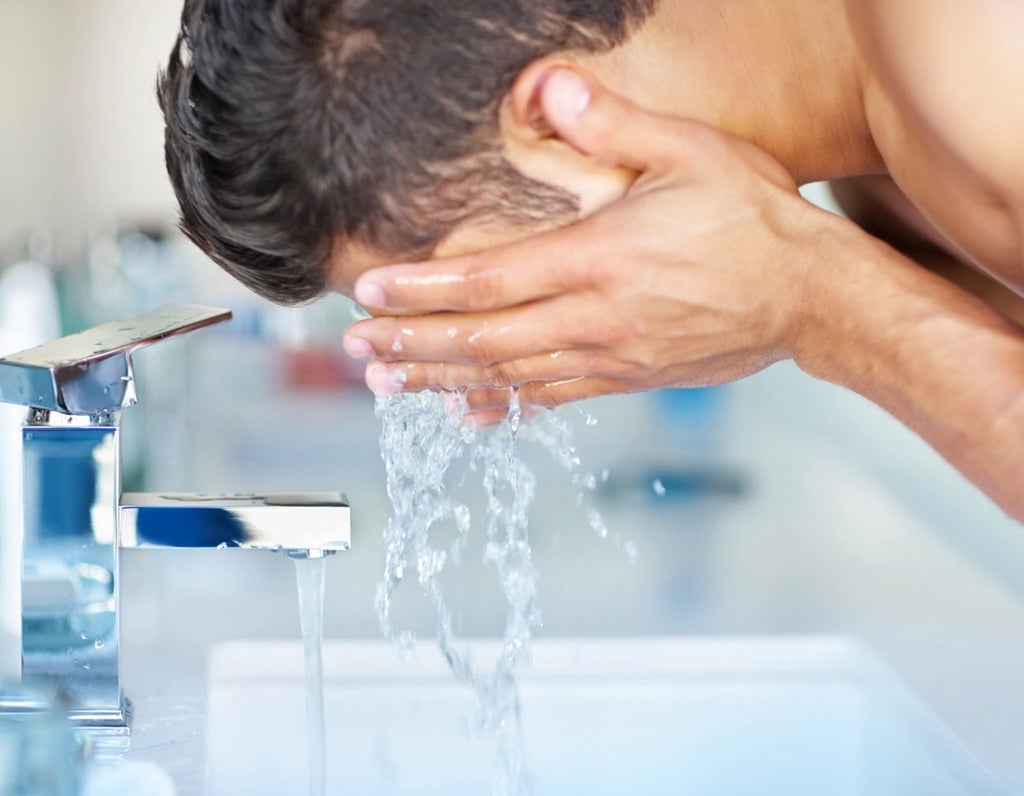 Man Washing His Face with Water