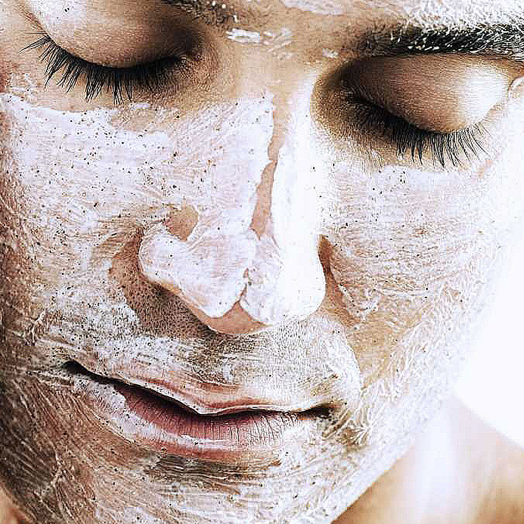 Man exfoliating his face