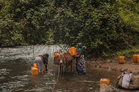 Meko Kabeto, 39, and Amane Mamu, 55, at their local river collecting water