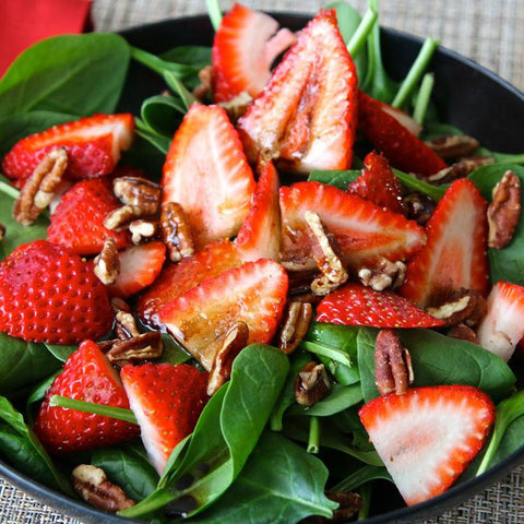 Colorful Summer Salad with fresh strawberries, spinach and nuts finished with a delicious balsamic vinaigrette made with honey!