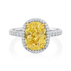 Platinum halo ring set with a 4.12 carat oval cut Fancy Intense Yellow diamond with SI1 clarity and 0.47 total carats of round brilliant cut diamonds 24148 