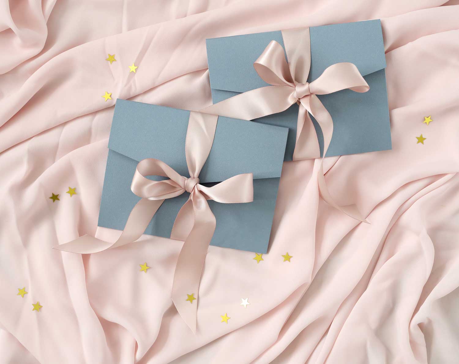 grey envelopes with blush coloured ribbon