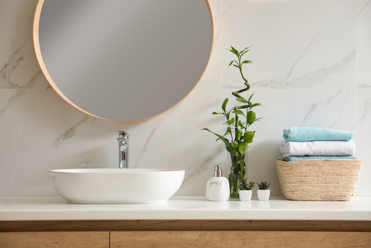 bathroom countertop and circular mirror